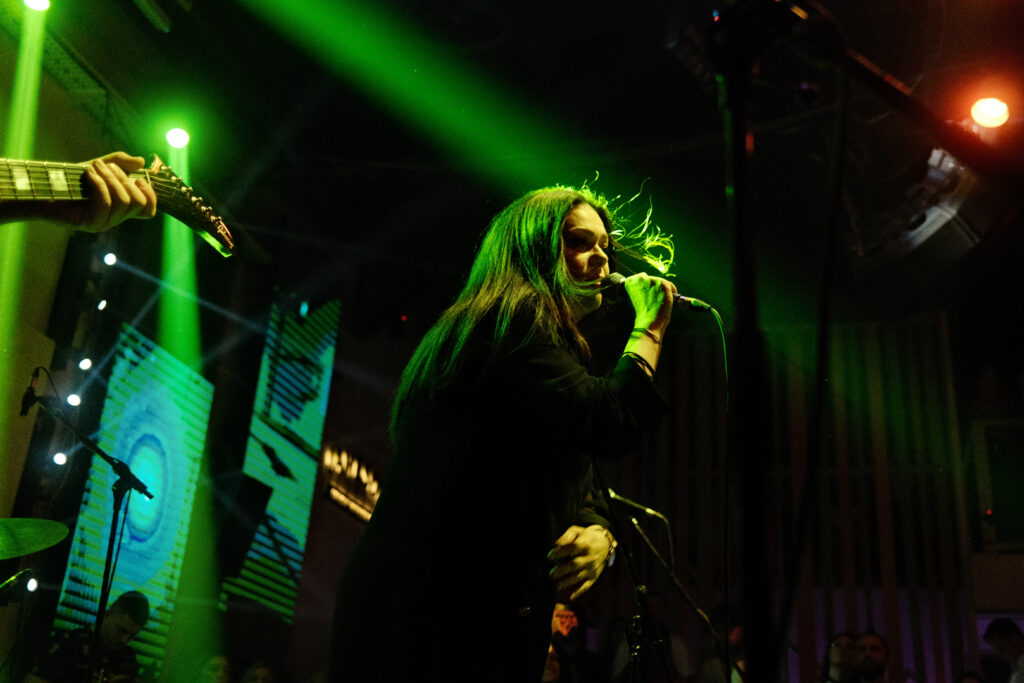 Musician performing on stage with microphone — performer agreements in NJ